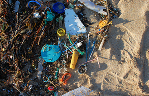 A collection of old straws and other plastic items on a beach. Credit: Marine Conservation Society.