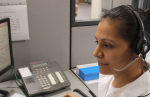 Helpline operator looking at computer
