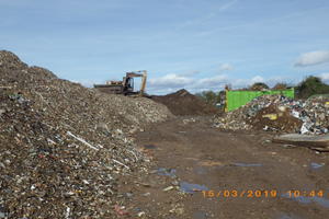 Piles of mixed waste, skips and equipment