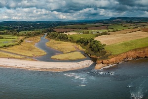 Aerial view of the River Otter flowing into the sea just east of Budleigh Salterton