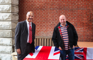 Two men smiling at the camera.