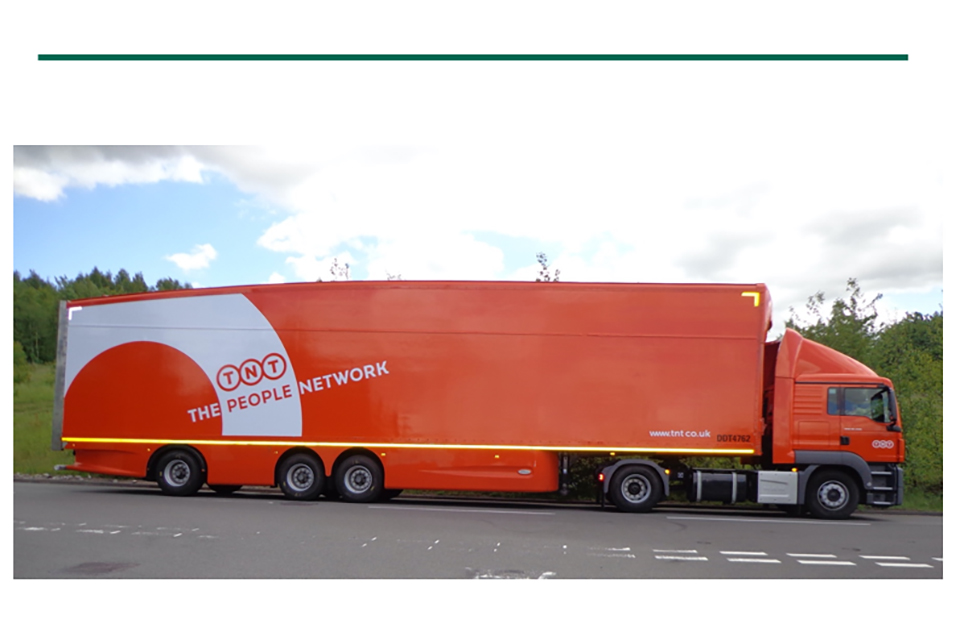 Tractor unit and longer semi-trailer in TNT livery beneath a section break