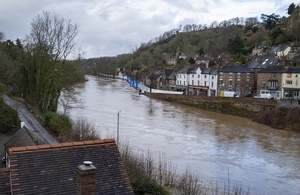 a swollen river in front of a town