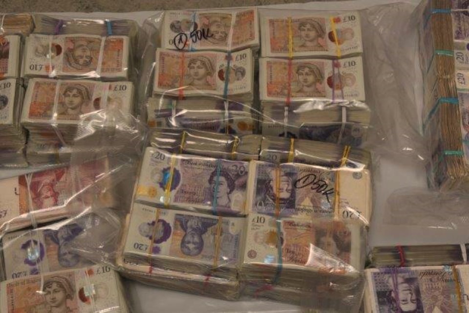 Two charged after cash stuffed into suitcases seized at Heathrow airport