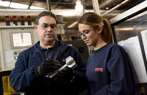 Image depicts a man and a woman working on a shell.