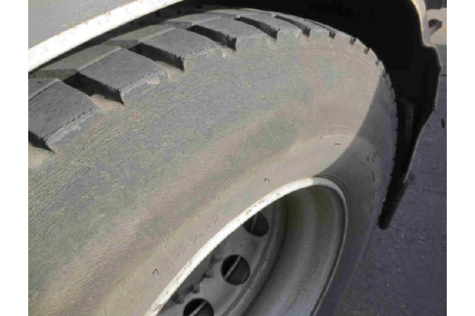 Sidewall heavily abraded with regulatory markings illegible, no cords visible, overheating or other damage evident