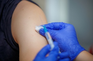 Close-up of a syringe and an arm