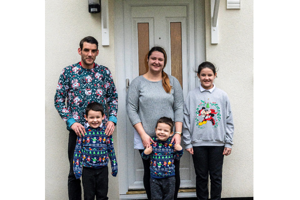 Corporal Angus, his wife Sarah and their children Paige, Bradley and Oscar standing outside their new home.