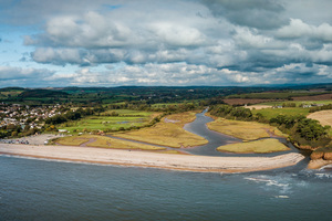 Aerial shot of the Jurassic coastline and where the River Otter meets the sea