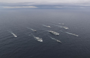 Image depicts the Carrier Strike Group at sea.