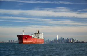 A commercial ship leaving a port in New York