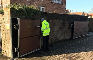 The images shows an Environment Agency staff member closing the flood gates at Yarm