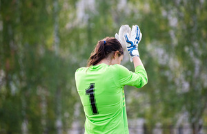 Female goalkeeper outside, wearing a number one jersey