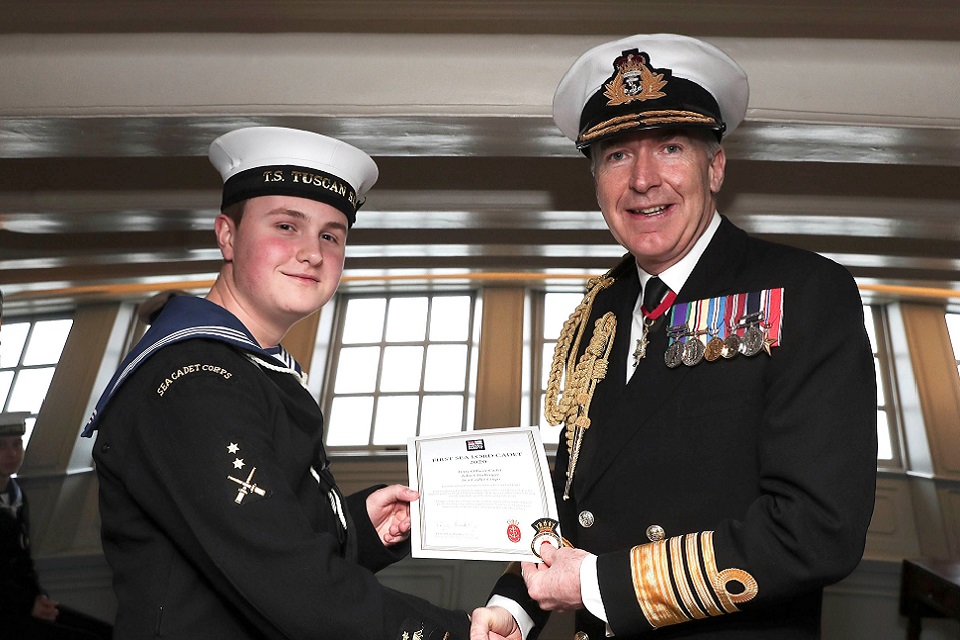 Sea cadet John Challenger being awarded a British Empire Medal (BEM) dressed in full service uniform. 