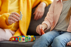 Image showing a child with toys and an adult sitting on a sofa