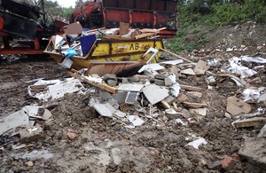 A messy yard and skip.