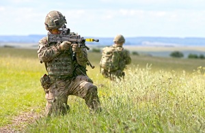 Soldiers holding a gun on exercise.