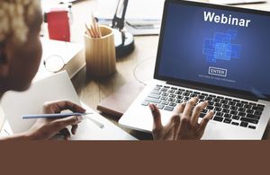 woman holding pen in front of computer