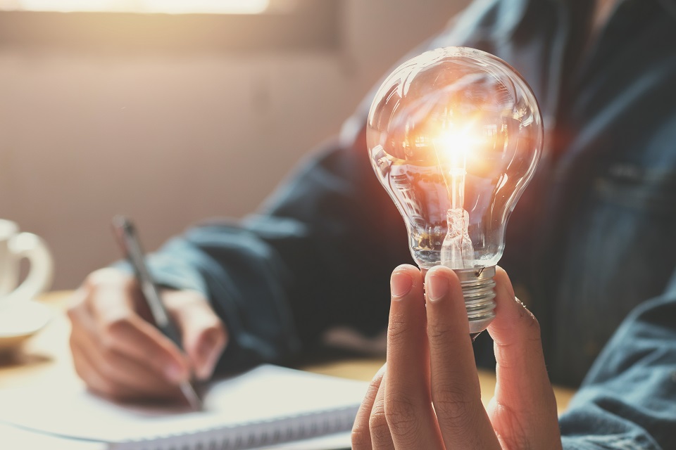 Person holding a light bulb