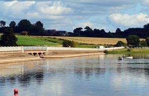 reservoir with a boat on it under blue sky