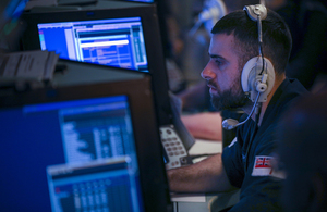 A military officer observes computer screens