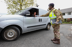 Military person helping with testing