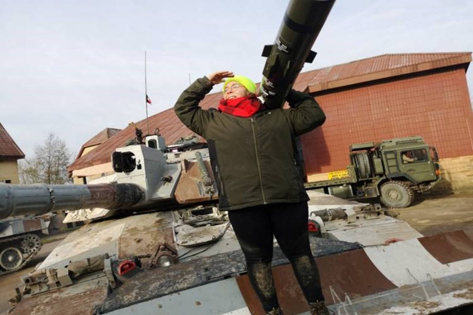 Louise standing on top of a tank