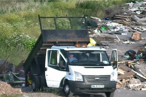 CCTV image of Crumlish sat inside a medium-sized truck as the rear elevates to tip waste