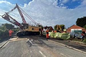 Contractors stood with large crane