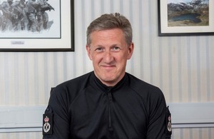 Ministry of Defence Police Chief Constable Andy Adams sitting at desk