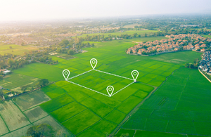 aerial view of green fields with location icons overlayed