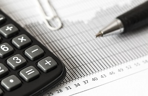 Image of calculator, pen and numbered table