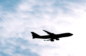 Plane flying on a cloudy sky.