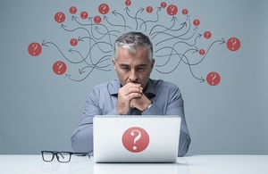 Pensive Businessman at Laptop