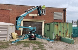 Officers installing the bat receiver at the pumping station.