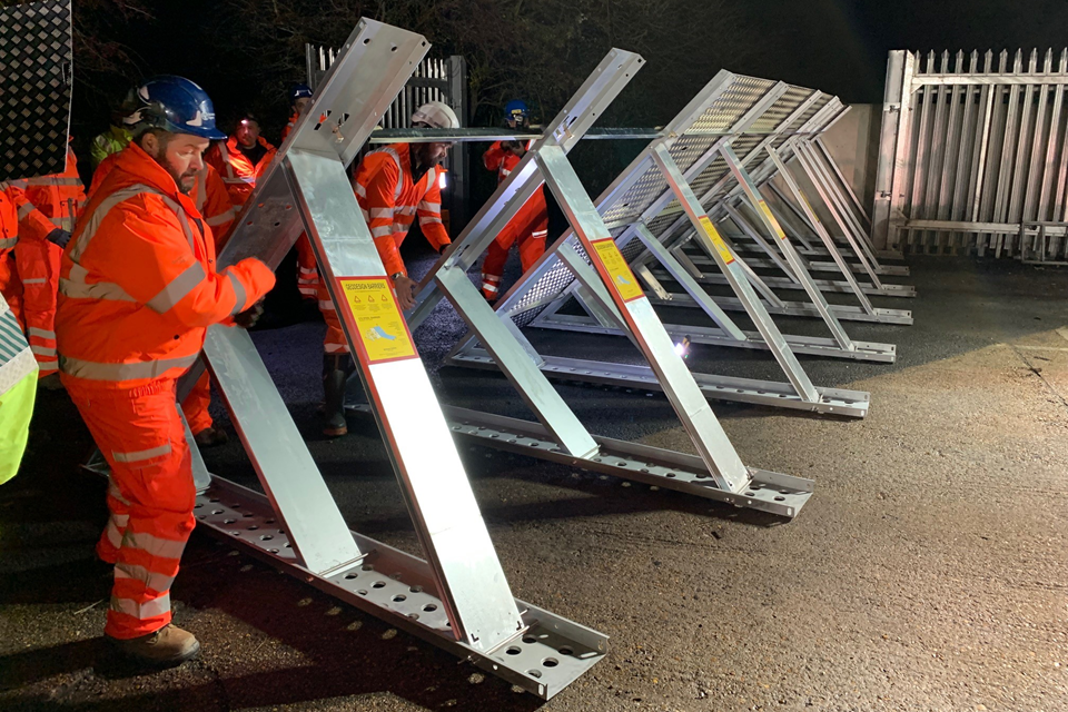 Flood barrier being temporarily installed across the railway at Newhaven, East Sussex