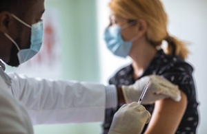 Young woman receiving a COVID-19 vaccination.