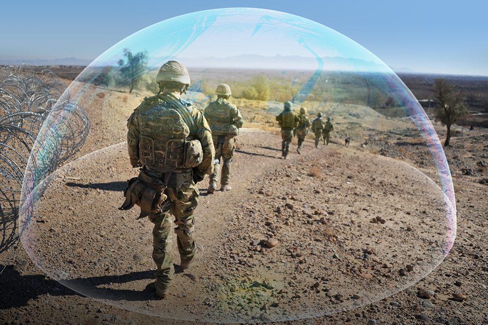 Soldiers walking outdoors surrounded by a graphic of a protective bubble