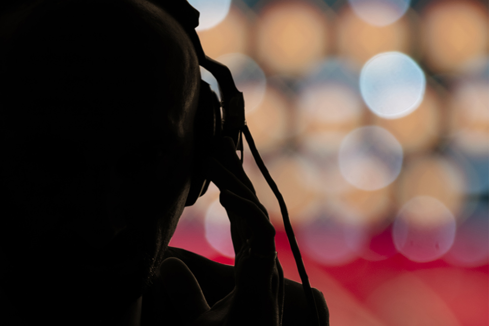 Silhouette of person listening through headphones