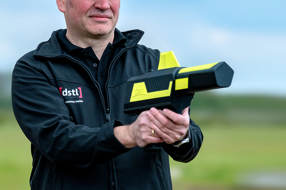 Dstl employee holds technology for tackling drones
