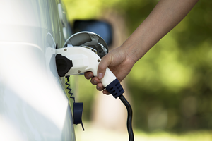 Image showing a person using an electric charging device for their electric car