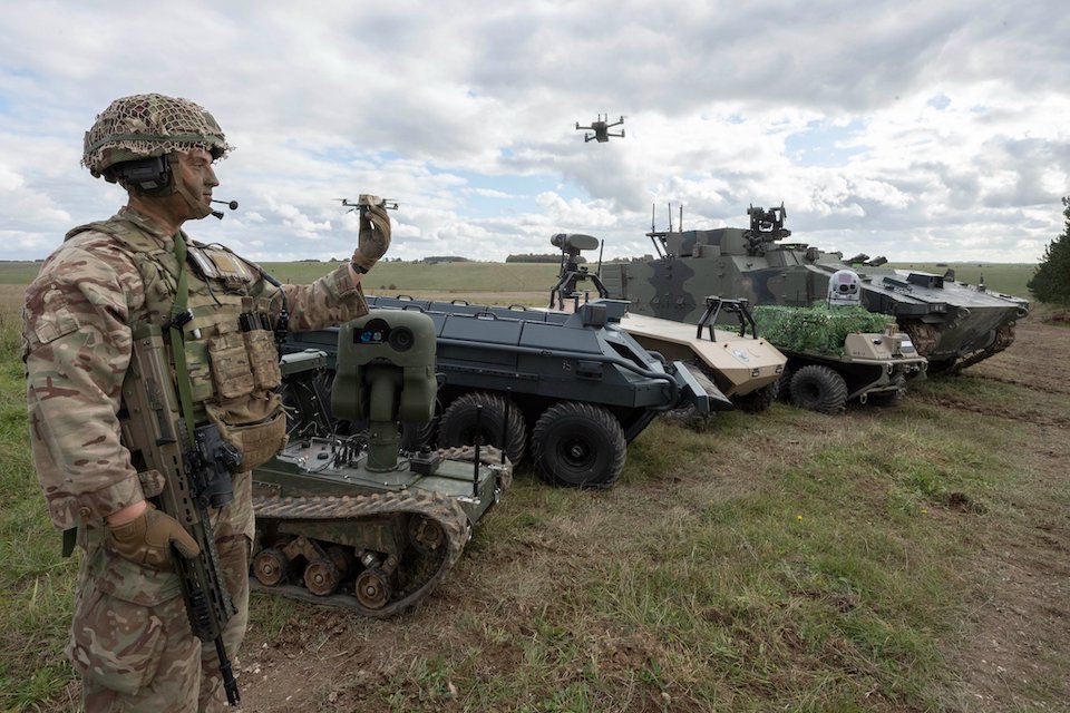 British Army personnel next to variety of vehicles and equipment