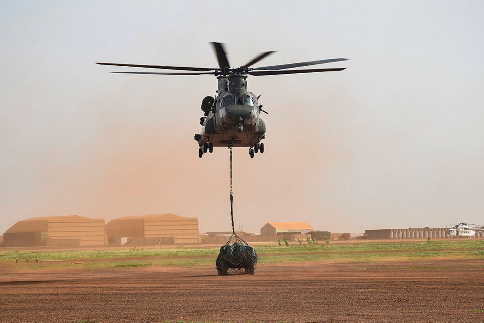 An RAF Chinook helicopter lifts a French Army Panhard armoured vehicle in Mali. 
