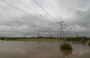 electricity pylons in flooded fields