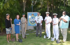 Crew of HMS Medway, UK Defence Attaché, and the UK High Commission Nassau Team posing before planting a tree.