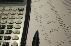 Calculator, pen and accounting notes
