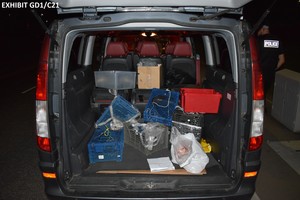 The back of a black vans, with crates in the boot, made to catch crayfish
