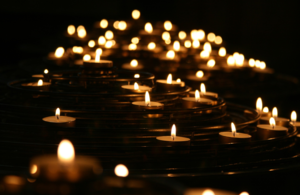 Multiple tea light candles burning at night