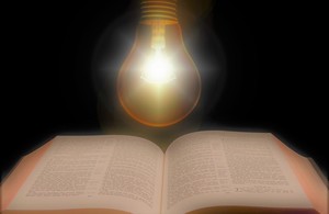 Electric Iightbulb shining above book