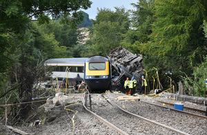 The derailment site and rail vehicles on the embankment at Carmont in Scotland
